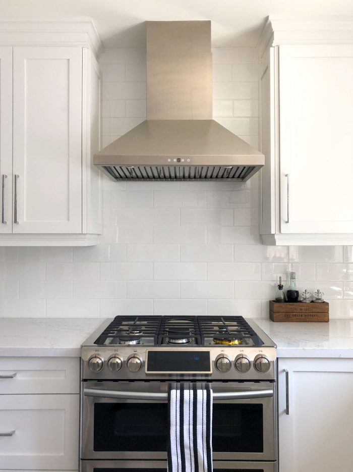 a custom range hood sits over a stove